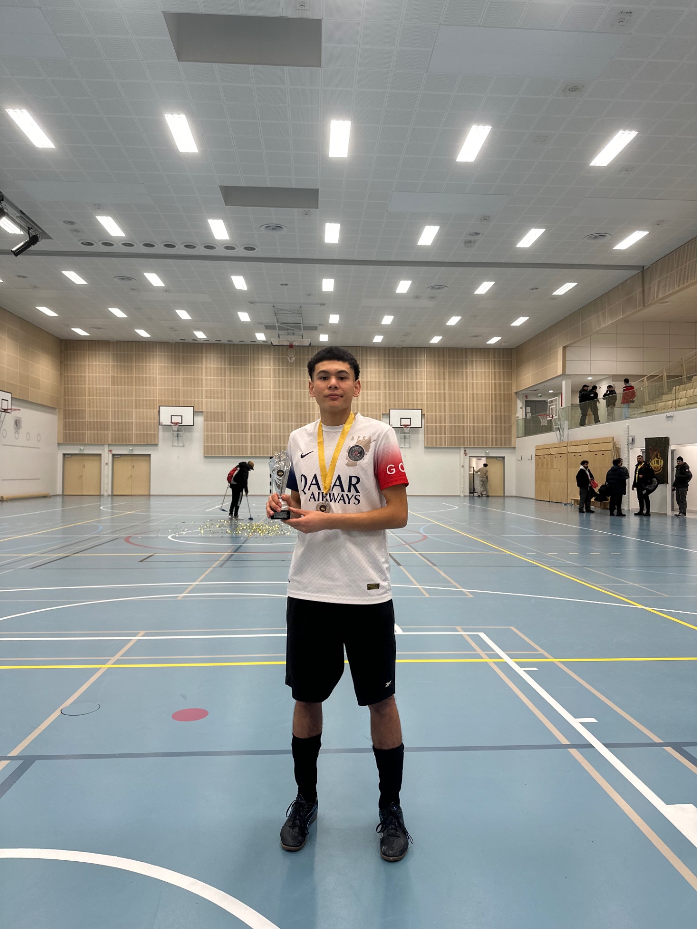 Young Shirdaghian FC player holding the trophy