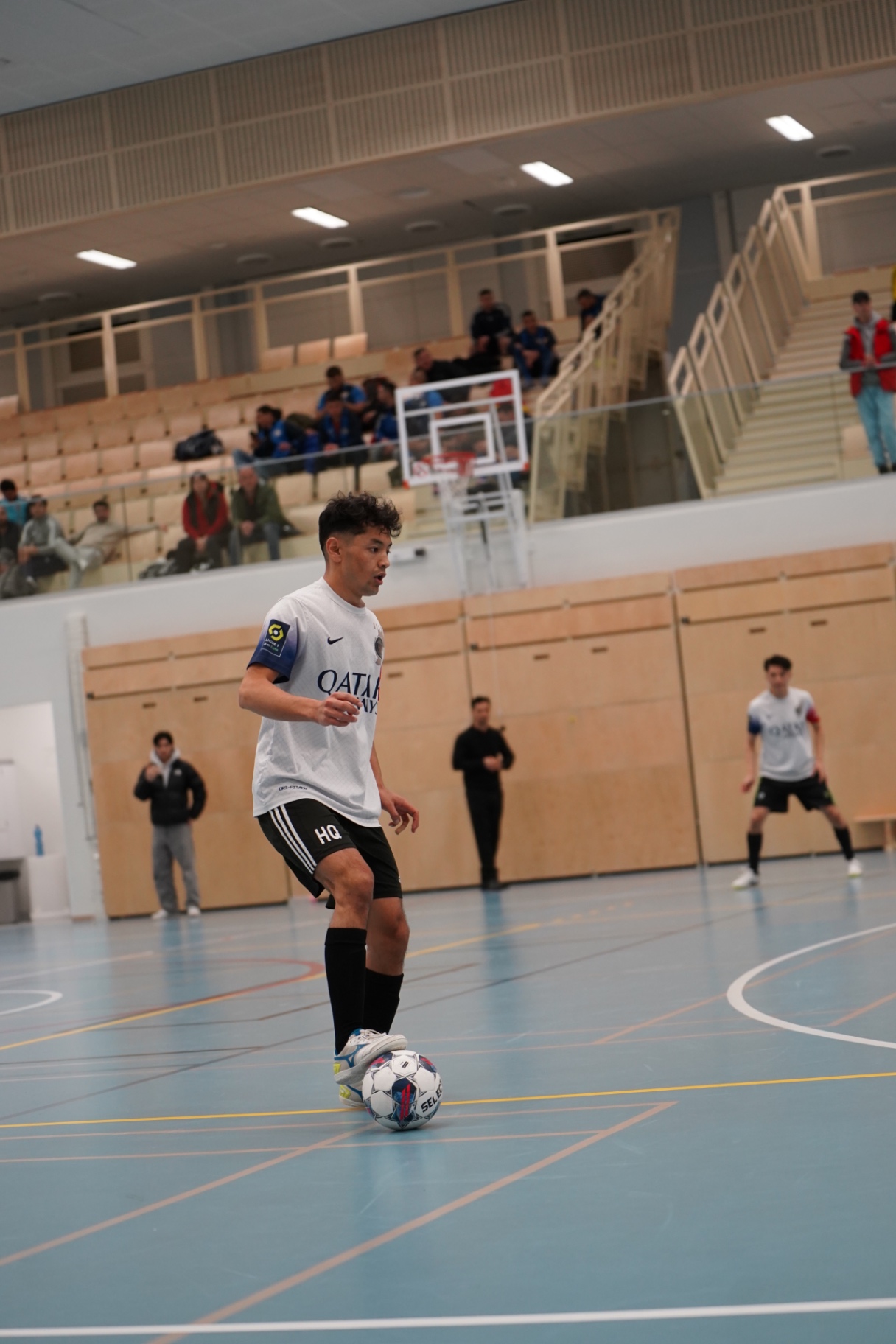 Shirdaghian FC player bringing the ball forward in front of the stands