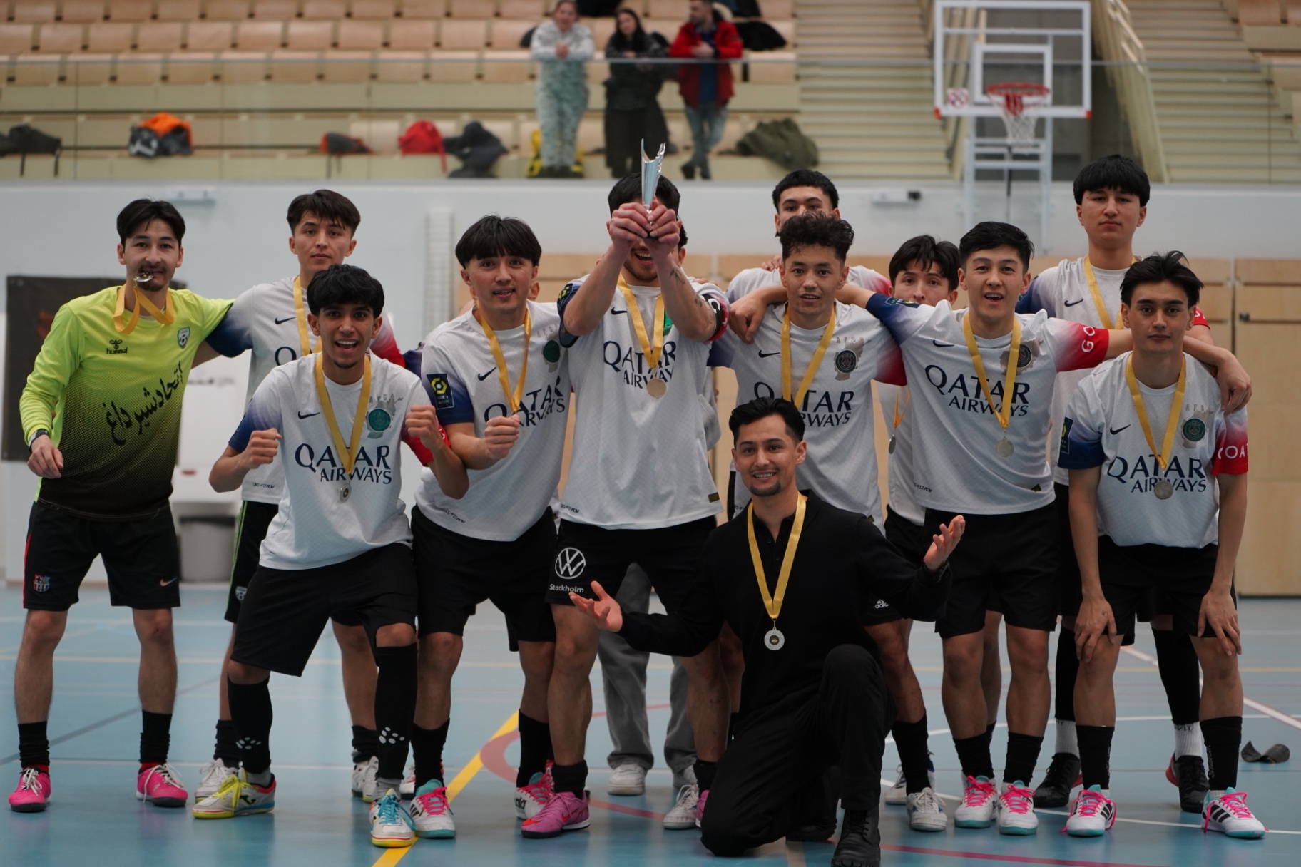 Shirdaghian FC celebrating with medals and the trophy