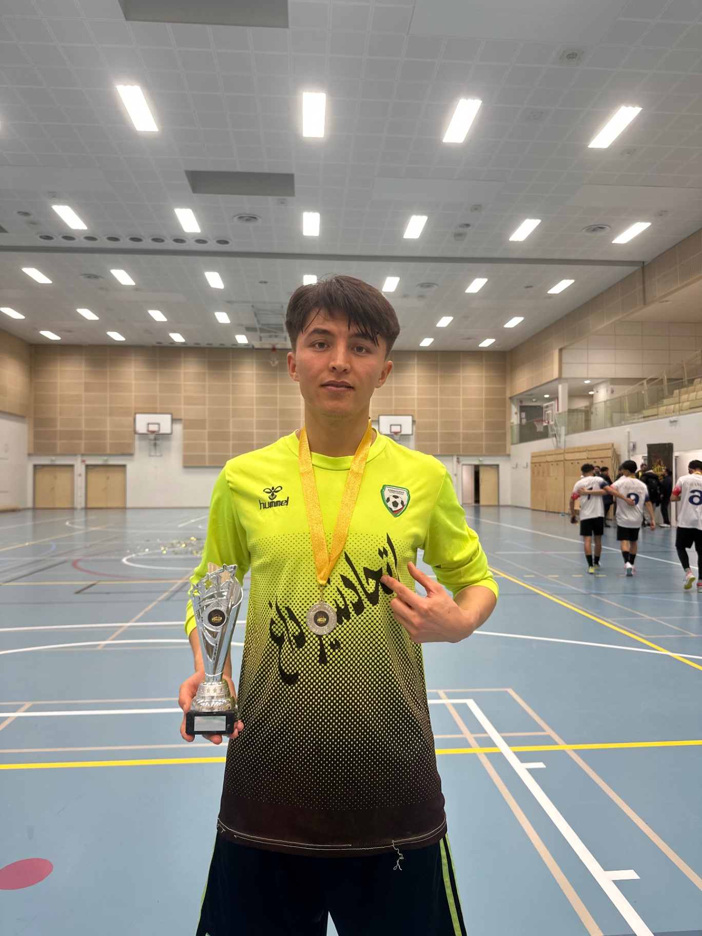 Shirdaghian FC goalkeeper with medal and trophy